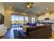 Cozy living room with a large couch, sliding glass doors to the backyard, and an open kitchen at 11257 Egeria Dr, Odessa, FL 33556
