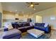 Open-concept living room and kitchen featuring hardwood floors, a comfortable sectional sofa, and modern appliances at 11257 Egeria Dr, Odessa, FL 33556