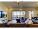 Inviting living room featuring a comfortable sectional sofa, ceiling fan, and sliding doors to a screened patio at 11257 Egeria Dr, Odessa, FL 33556