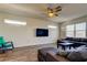Comfortable living room with a gray sectional sofa, a mounted TV, and a view of the window at 11257 Egeria Dr, Odessa, FL 33556