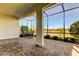 Covered patio offering tranquil pond views and a seating area, perfect for outdoor enjoyment at 11257 Egeria Dr, Odessa, FL 33556