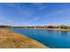 Breathtaking view of a tranquil pond reflecting the clear blue sky and nearby homes at 11257 Egeria Dr, Odessa, FL 33556