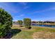 Scenic pond view surrounded by well-manicured greenery and beautiful homes at 11257 Egeria Dr, Odessa, FL 33556