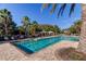 Large rectangular community pool area with palm trees, seating, and cabanas at 11257 Egeria Dr, Odessa, FL 33556