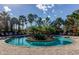 Inviting pool with a circular island, palm trees, and comfortable lounge chairs around perimeter at 11257 Egeria Dr, Odessa, FL 33556
