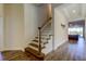View of the staircase, foyer and hardwood floors and a glimpse of an open concept living space at 11257 Egeria Dr, Odessa, FL 33556