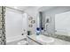 Neat bathroom features a granite countertop, a sink, and a shower-tub combo with a nice shower curtain at 11347 Crescent Deer Dr, Land O Lakes, FL 34638