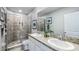 Bright bathroom with a double vanity, granite countertops, and a tiled walk-in shower at 11347 Crescent Deer Dr, Land O Lakes, FL 34638