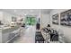 Open concept dining and living room with tile floors, white brick accent wall, and lots of natural light at 11347 Crescent Deer Dr, Land O Lakes, FL 34638