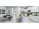 Bright open-concept kitchen featuring stainless steel appliances, white cabinets, a large island and barstool seating at 11347 Crescent Deer Dr, Land O Lakes, FL 34638