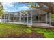 View of the backyard with screened pool, patio, and mature trees at 1166 Lumsden Trace Cir, Valrico, FL 33594