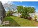 Lush backyard featuring tropical landscaping and a pristine white fence for added privacy at 1166 Lumsden Trace Cir, Valrico, FL 33594