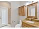 Bathroom vanity with framed mirror, wooden cabinets, and granite countertops offers luxurious feel at 1166 Lumsden Trace Cir, Valrico, FL 33594