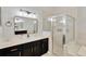 Bathroom vanity with double sinks, framed mirror, and glass-enclosed shower offering luxurious features at 1166 Lumsden Trace Cir, Valrico, FL 33594