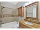 Bright bathroom with updated vanity, granite countertop, tiled walls, and shower with tub at 1166 Lumsden Trace Cir, Valrico, FL 33594
