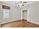 Bedroom featuring hardwood floors, closet with double doors and a window for natural light inside the home at 1166 Lumsden Trace Cir, Valrico, FL 33594
