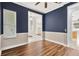 Bedroom featuring blue walls, white trim, wood flooring and a window at 1166 Lumsden Trace Cir, Valrico, FL 33594