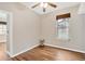Comfortable bedroom featuring hardwood floors, a ceiling fan, and a bright window for natural light at 1166 Lumsden Trace Cir, Valrico, FL 33594