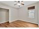 Bedroom featuring hardwood flooring, a ceiling fan, a window with shade, and a closet at 1166 Lumsden Trace Cir, Valrico, FL 33594