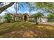 Charming home featuring a two-car garage, tidy landscaping, and mature trees in a residential neighborhood at 1166 Lumsden Trace Cir, Valrico, FL 33594