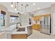 Bright kitchen features stainless steel appliances, counter seating, and tile flooring at 1166 Lumsden Trace Cir, Valrico, FL 33594