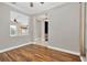 Open-concept living room with wood floors and views of adjoining rooms at 1166 Lumsden Trace Cir, Valrico, FL 33594