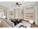 Well-lit living room showcasing hardwood floors, display shelves, and neutral tones throughout the interior design at 1166 Lumsden Trace Cir, Valrico, FL 33594