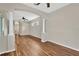 Living room featuring wood flooring, arches, and views of the bathroom at 1166 Lumsden Trace Cir, Valrico, FL 33594