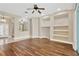 Living room featuring built-in shelves, wood flooring, and an open layout at 1166 Lumsden Trace Cir, Valrico, FL 33594