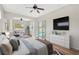 Spacious main bedroom featuring an ensuite seating area, direct access to the pool, and hardwood floors at 1166 Lumsden Trace Cir, Valrico, FL 33594