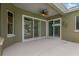 Covered patio with ceiling fan, offering views of the screened pool at 1166 Lumsden Trace Cir, Valrico, FL 33594