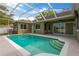 Inviting in-ground screened pool with pool with steps leading into the water at 1166 Lumsden Trace Cir, Valrico, FL 33594