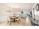 Open concept dining and living area with neutral paint, tile flooring, and decorative lighting at 139 Bluff View Dr # 105, Belleair Bluffs, FL 33770