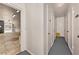 Storage units lining a hallway of a building, with an open view to an exterior walkway at 139 Bluff View Dr # 105, Belleair Bluffs, FL 33770