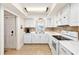 Well-lit kitchen featuring white appliances, cabinets, and tile flooring with backyard views at 139 Bluff View Dr # 105, Belleair Bluffs, FL 33770