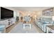 Spacious living room with tile floors, light blue sofas, and an open layout at 139 Bluff View Dr # 105, Belleair Bluffs, FL 33770