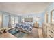 Inviting main bedroom with a palm-themed bedspread, and light blue walls at 139 Bluff View Dr # 105, Belleair Bluffs, FL 33770