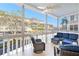 Enclosed lanai with a ceiling fan and comfortable seating overlooking a view of the community at 139 Bluff View Dr # 105, Belleair Bluffs, FL 33770