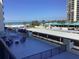 Spacious balcony with seating overlooking the beach and parking area at 1400 Gulf Blvd # 204, Clearwater Beach, FL 33767