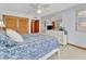 Comfortable bedroom with large dresser, blue and white bedspread, and sliding door to balcony at 1400 Gulf Blvd # 204, Clearwater Beach, FL 33767