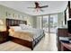 Well-lit bedroom showcasing a spacious layout, ceiling fan, and balcony access with nice city views at 1400 Gulf Blvd # 204, Clearwater Beach, FL 33767