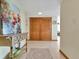 Welcoming entryway with tile flooring, decor, and double doors, enhanced by a vibrant art piece at 1400 Gulf Blvd # 204, Clearwater Beach, FL 33767