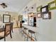 Well-lit breakfast bar with pendant lights and a view into the kitchen with stainless appliances at 1400 Gulf Blvd # 204, Clearwater Beach, FL 33767