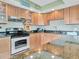 Well-lit kitchen featuring granite countertops, stainless steel appliances, and ample cabinet space at 1400 Gulf Blvd # 204, Clearwater Beach, FL 33767