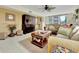 Living room with a comfortable sofa, large windows and coastal decor at 1400 Gulf Blvd # 204, Clearwater Beach, FL 33767