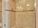 Large tiled walk in shower with mosaic tile accents and glass door at 1400 Gulf Blvd # 204, Clearwater Beach, FL 33767