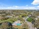 An aerial view of the community showing the pool, beautiful mature trees, and glimpses of the open water at 158 Brigton Ct, Safety Harbor, FL 34695