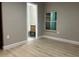 Comfortable bedroom with hardwood floors, a window, and a doorway leading to an ensuite bathroom at 1615 39Th S St, St Petersburg, FL 33711