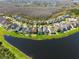 An aerial view showcases lakeside homes, offering community charm and scenic appeal at 18855 Hampstead Heath Ct, Land O Lakes, FL 34638