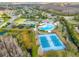 Expansive aerial view showcasing community amenities including tennis courts and a pool at 18855 Hampstead Heath Ct, Land O Lakes, FL 34638